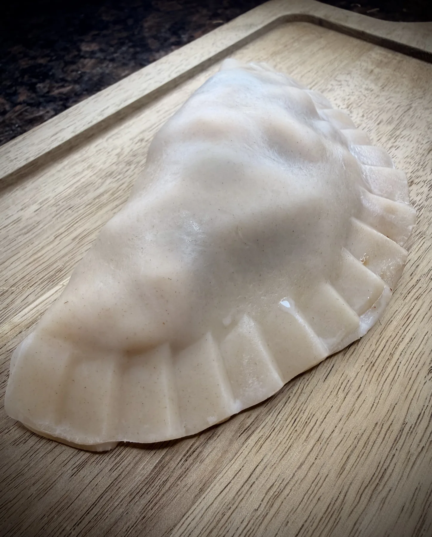 A close view of an actual hand-crimped Empanada Sonata Take and Make empanada before frying