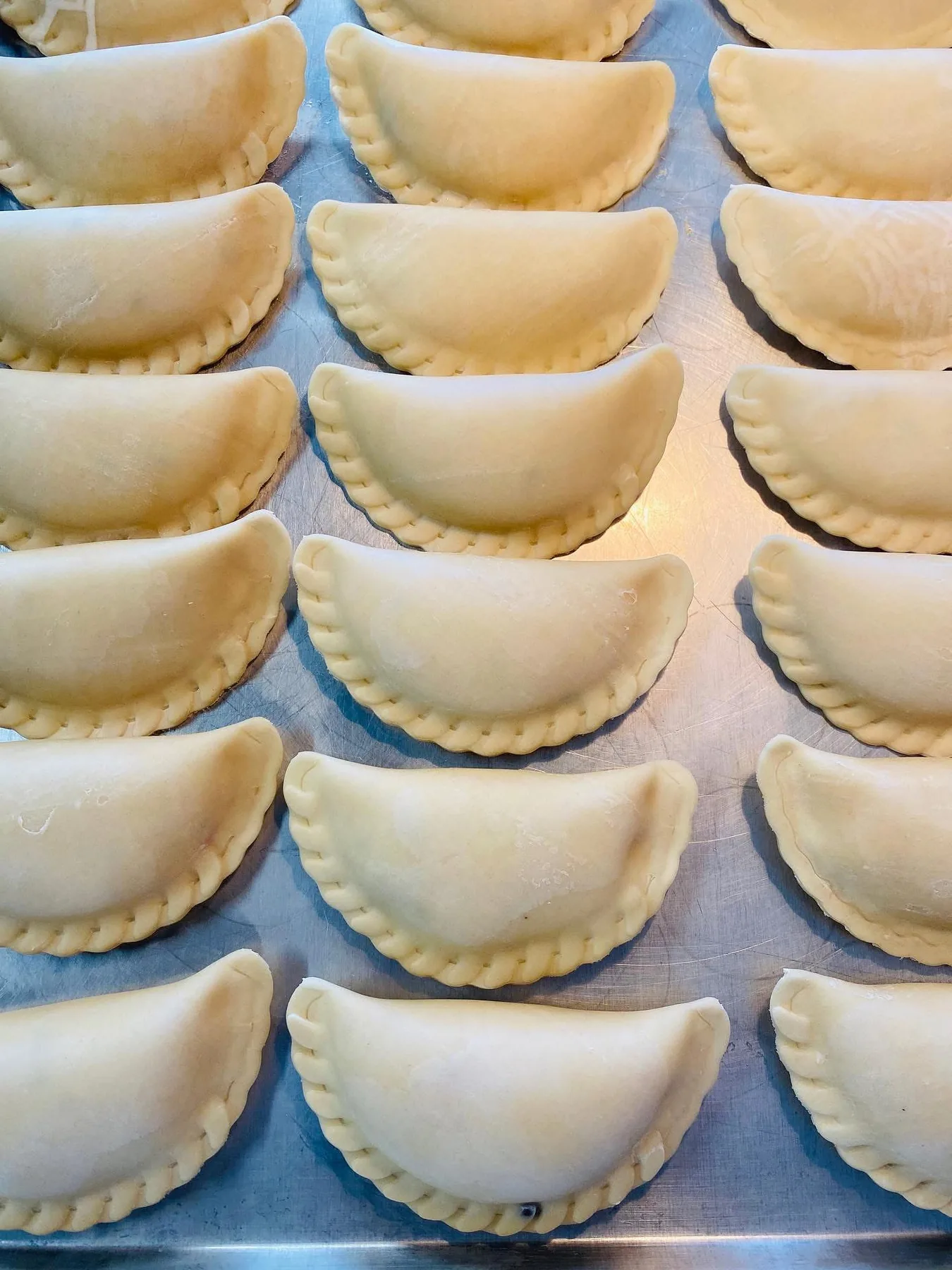 Actual uncooked Empanada Sonata empanadas arranged for production