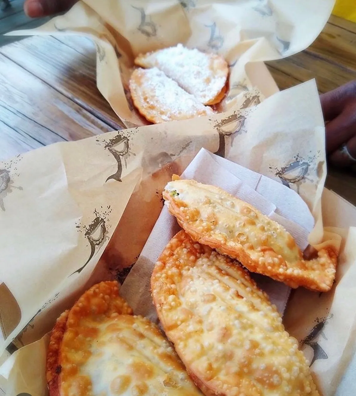 People sharing actual Empanada Sonata empanadas and sweet turnovers